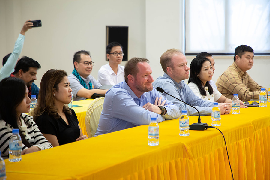 Devin Barta, President of AmCham Cambodia, sitting with other members of the AmCham delegation (including Tom O'Sullivan) during a delegation tour of Sihanoukville