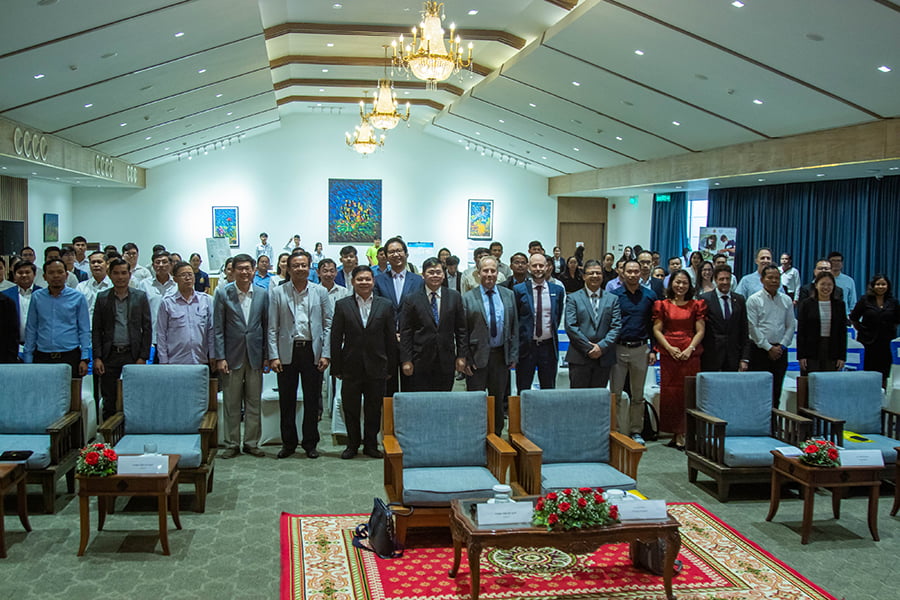 The Digital Literacy Initiative (DLI) was officially launched on January 18, 2024, at the Himawari Hotel Apartments - audience stands together and poses for photo with distinguished guests at the launch ceremony of the DLI program in Cambodia